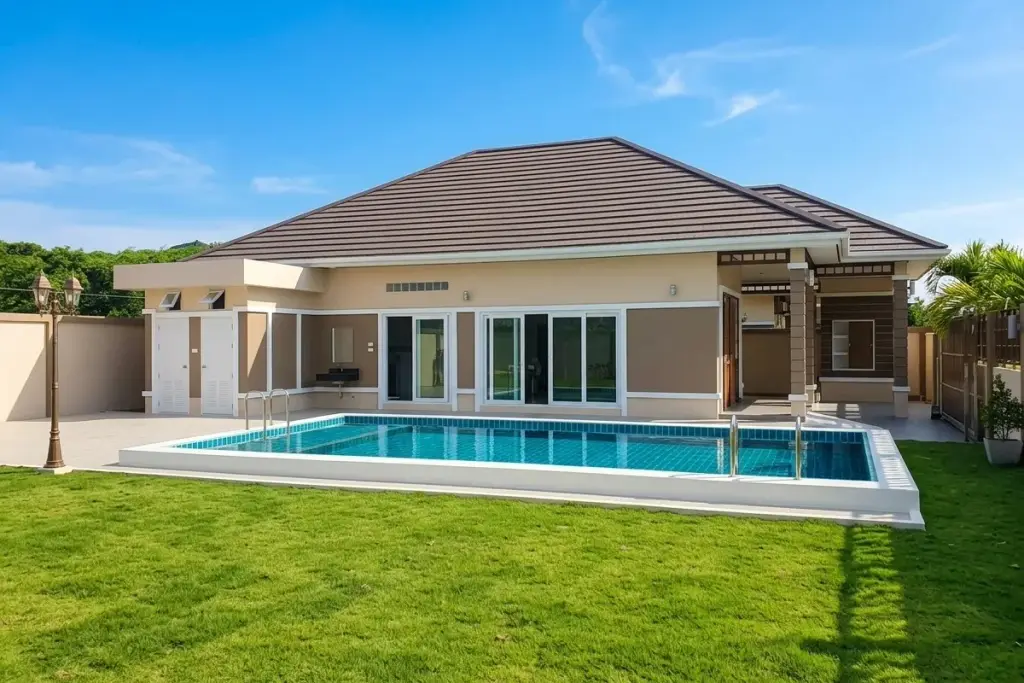 Living Grand Home single-story house with private swimming pool and green lawn under a clear blue sky.