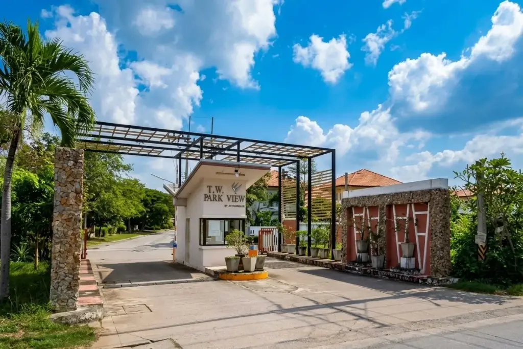 T.W. Park View main entrance gate with a security guardhouse and property signage under a metal archway.