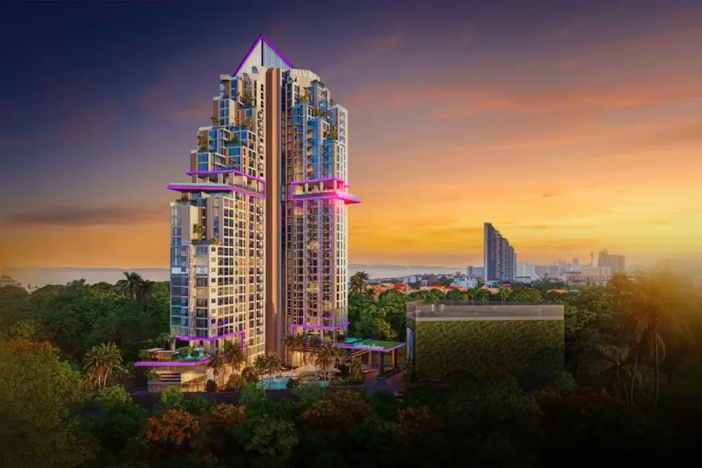 The Riviera Santa Monica modern high-rise building with purple accent lighting against a vibrant sunset sky.