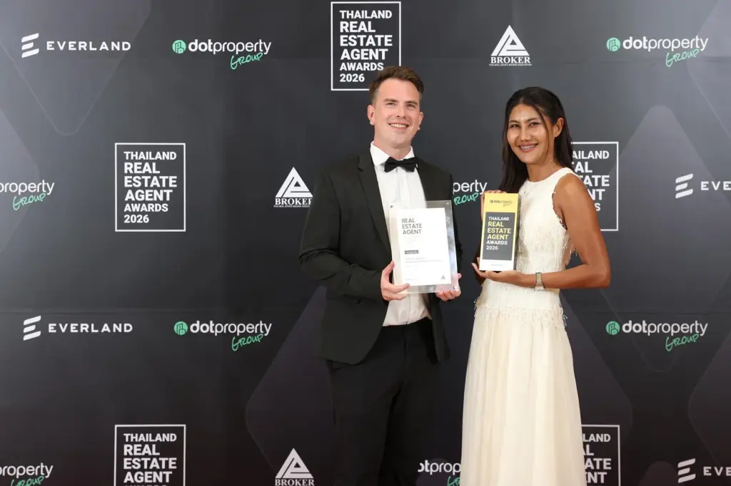 Two Pearl Property representatives holding the award and certificate at the Thailand Real Estate Agent Awards 2026