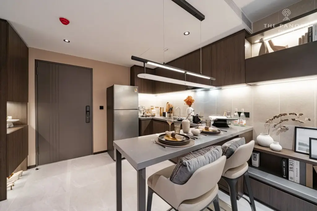 2 Bedroom Condo for Sale at Panora Estuaria master bedroom with king bed, wall-mounted TV, and walk-in closet