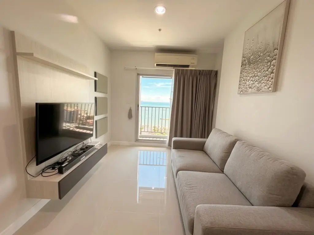 2 Bedroom Condo for Sale at Centric Sea living room with sea view balcony and mounted TV