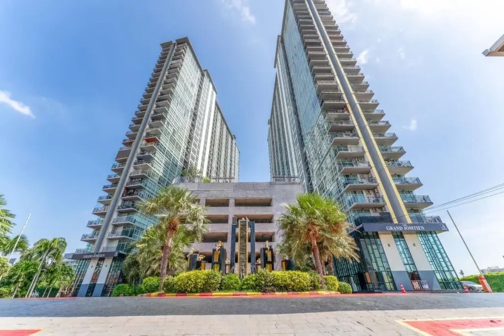The Twin Tower Jomtien Beach Pattaya grand entrance facade with twin high-rise towers palm trees and Grand Jomtien signage