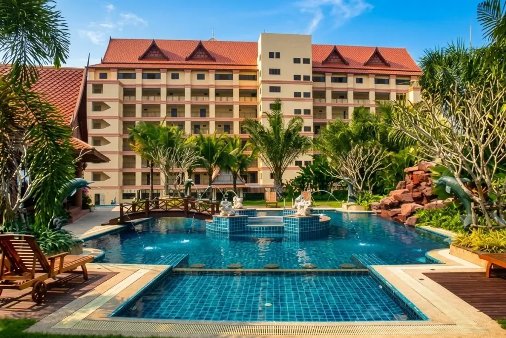 Nova Mirage Wongamat large swimming pool with fountains, a decorative bridge, and a multi-story condo building.