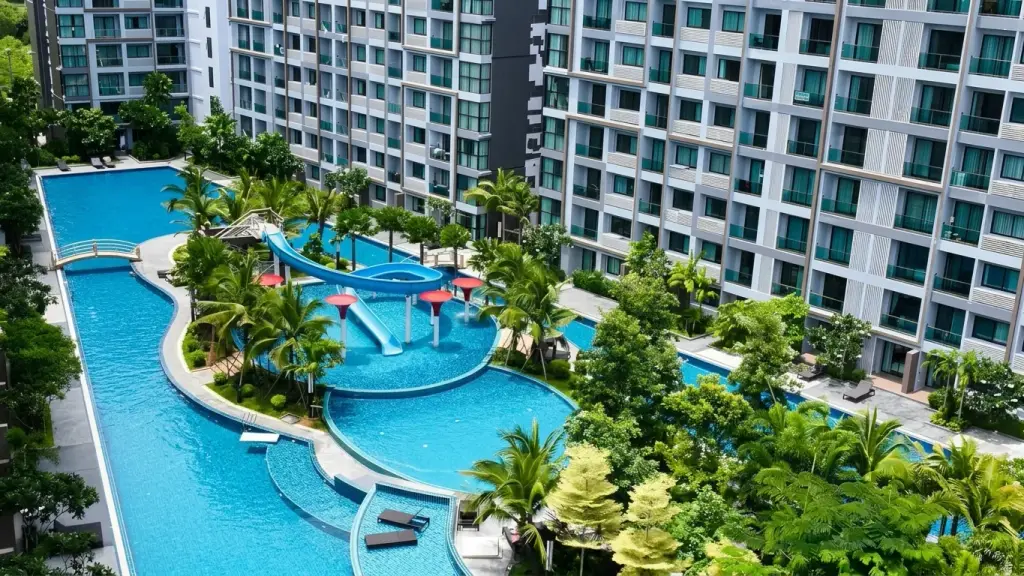 Dusit Grand Park 1 aerial view of lagoon pool with water slide surrounded by condo towers