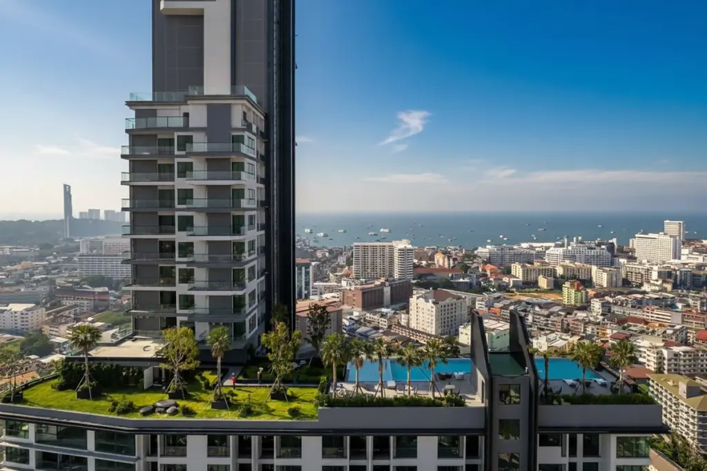 Arcadia Millennium Tower high-rise building with rooftop garden and pool, overlooking Pattaya city and the ocean.