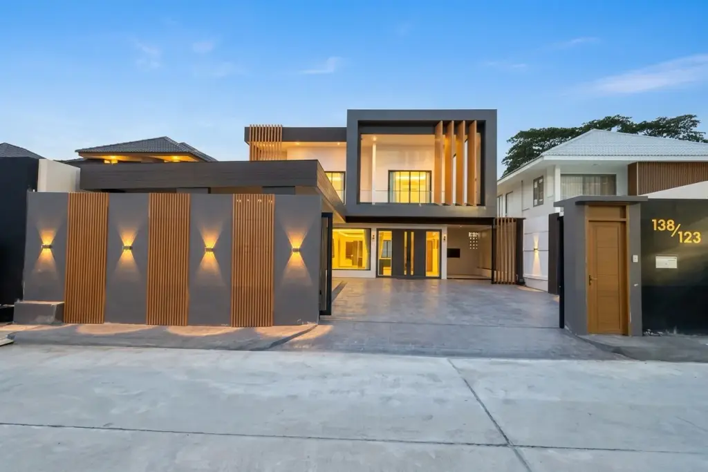 5 Bedroom House for Rent at View Point Village modern two-story facade with wood accents at dusk