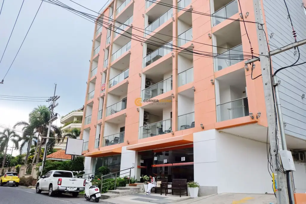 C View Residence 2 living room with brown sofa, Thai wall art, and balcony access in Pattaya condo