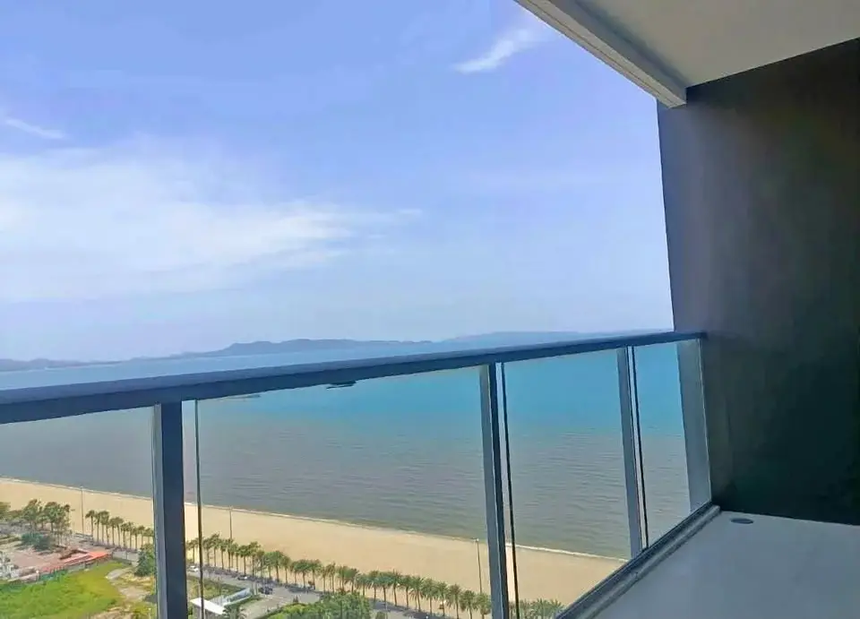 1 Bedroom Condo for Sale at Cetus Beachfront balcony view of ocean and palm-lined beach promenade