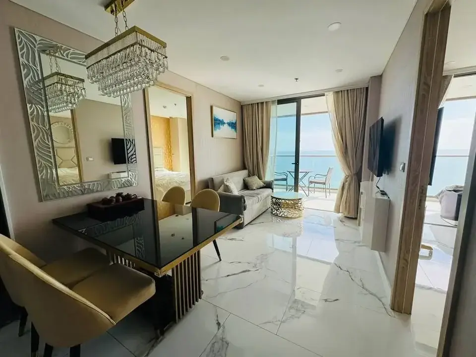 2 Bedroom Condo for Sale at Copacabana Beach Jomtien living and dining area with crystal chandelier and sea view balcony