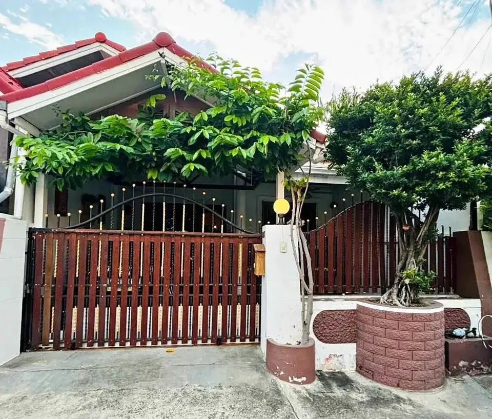 2 Bedroom House for Rent at Eakmongkol 4 house exterior with red tiled roof, gate and garden trees