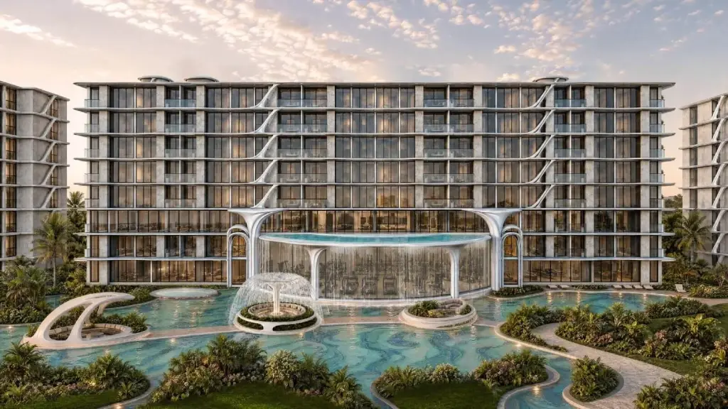 Embassy World condo exterior facade with glass balconies, waterfall feature pool, and fountain at dusk in Pattaya