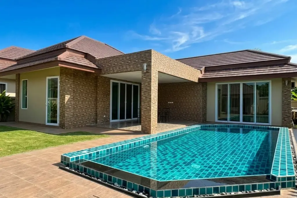 Amaliya Village private swimming pool and modern house exterior with covered patio and sliding glass doors.