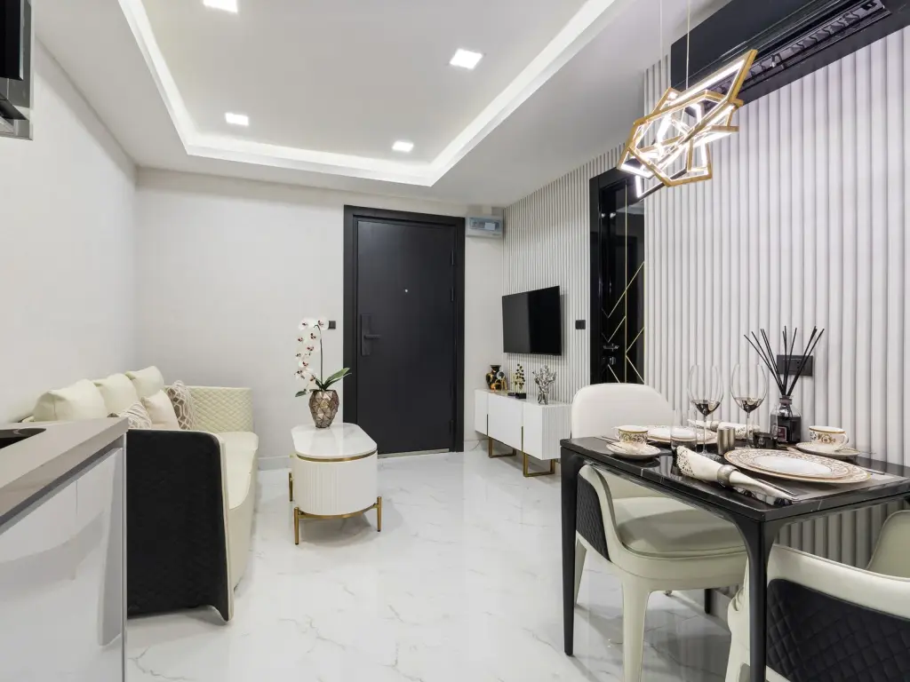 1 Bedroom Condo for Sale at Grand Solaire Noble living room with mirrored wall, white sofa and dining nook