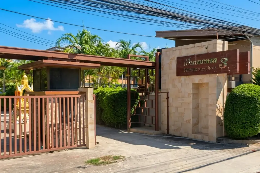 Baan Piam Mongkhon 3 entrance gate with stone wall and property name sign in Thai and English.