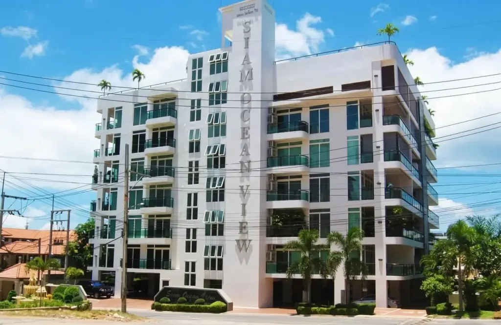 Siam Ocean View condo exterior facade with balconies and signage under blue sky in Pattaya