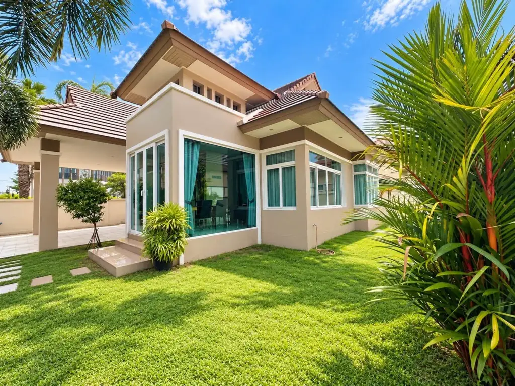 3 Bedroom House for Rent in Mabprachan exterior view with lush green lawn and tropical palm trees