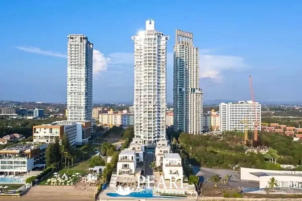 La Royale Beach aerial view of large outdoor swimming pool with lounge area and modern white buildings.