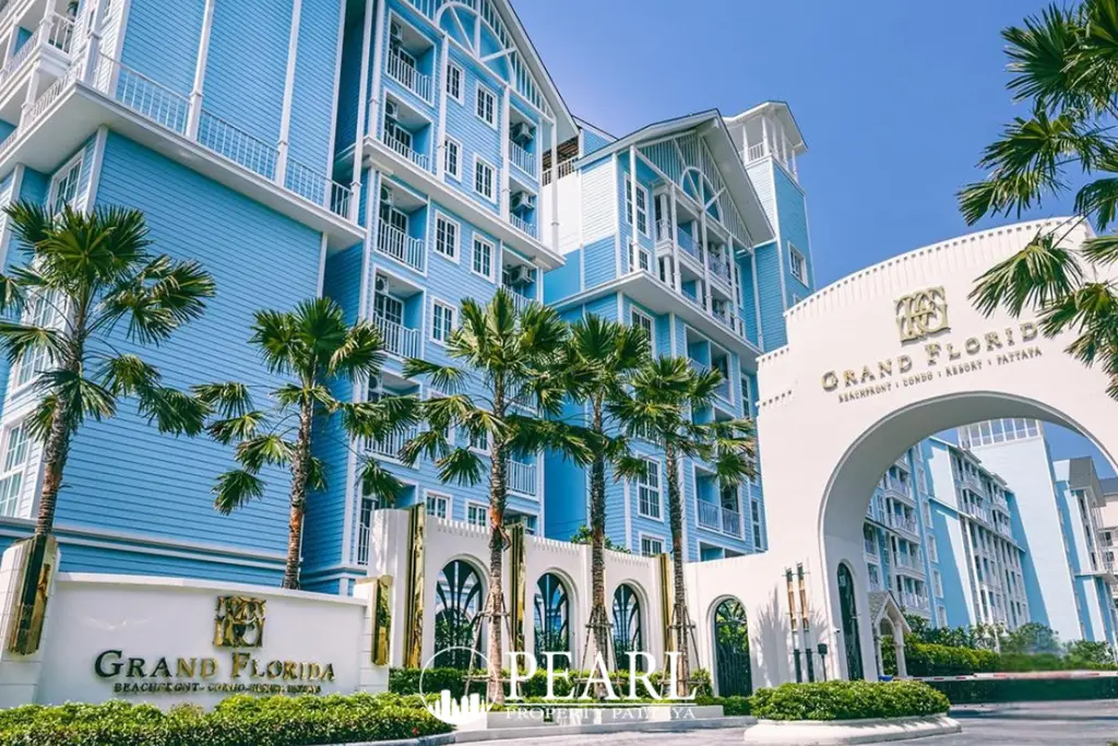 Grand Florida Beachfront Condo Resort Pattaya exterior, light blue buildings, palm trees, and main archway entrance sign.