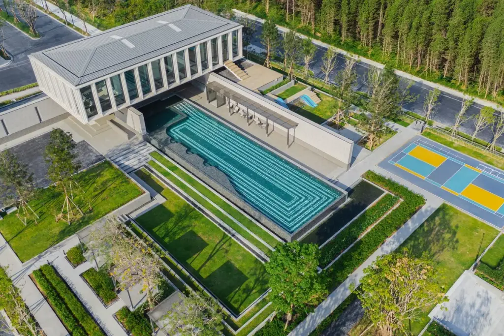 Cascade modern two-story house exterior with carport, large windows, and decorative water feature.