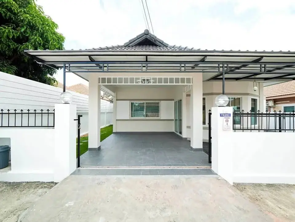 3 Bedroom House for Sale at Raviporn City Home exterior view with covered carport and gated entrance