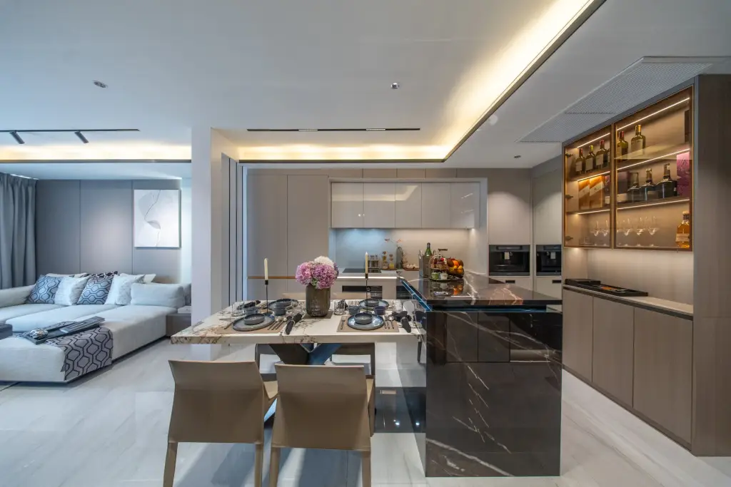 1 Bedroom Condo for Sale at Sea Sky By Sand open-plan living area with dining table, kitchen island and wine display