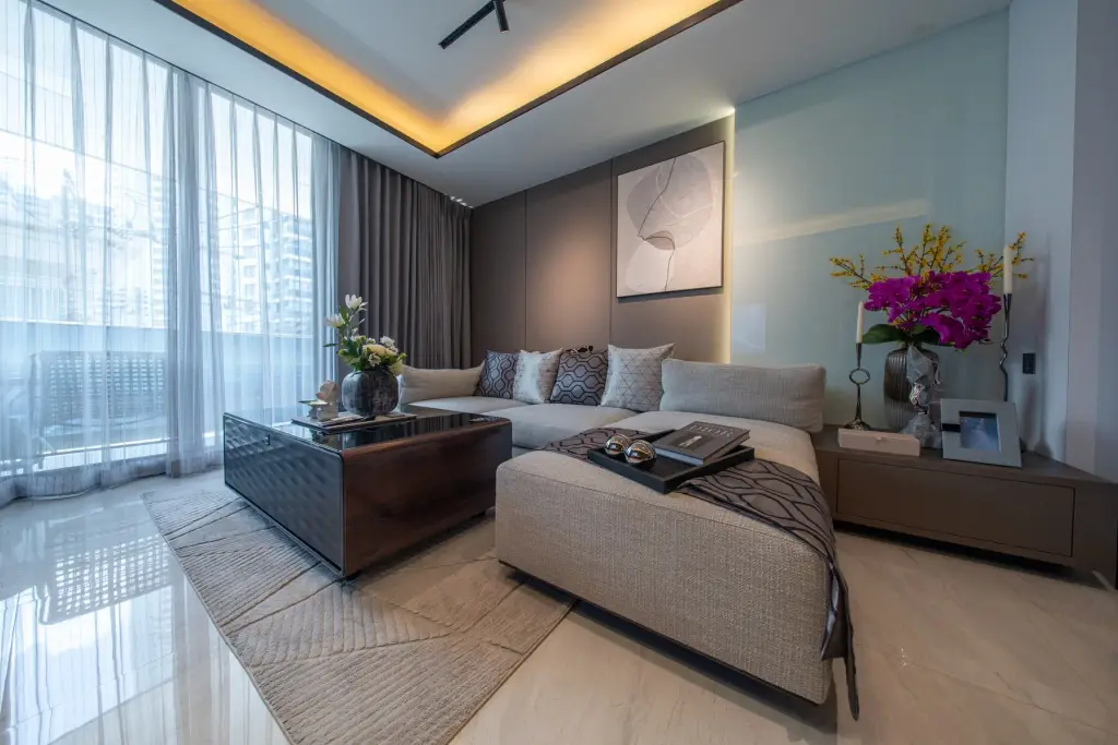 1 Bedroom Condo for Sale at Sea Sky By Sand living room with sectional sofa, coffee table and city view windows