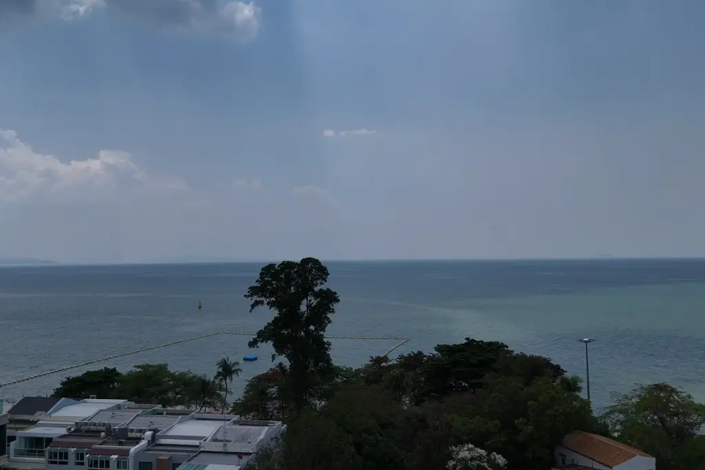 1 Bedroom Condo for Sale at Sea Sky By Sand ocean view from balcony with trees and distant coastline