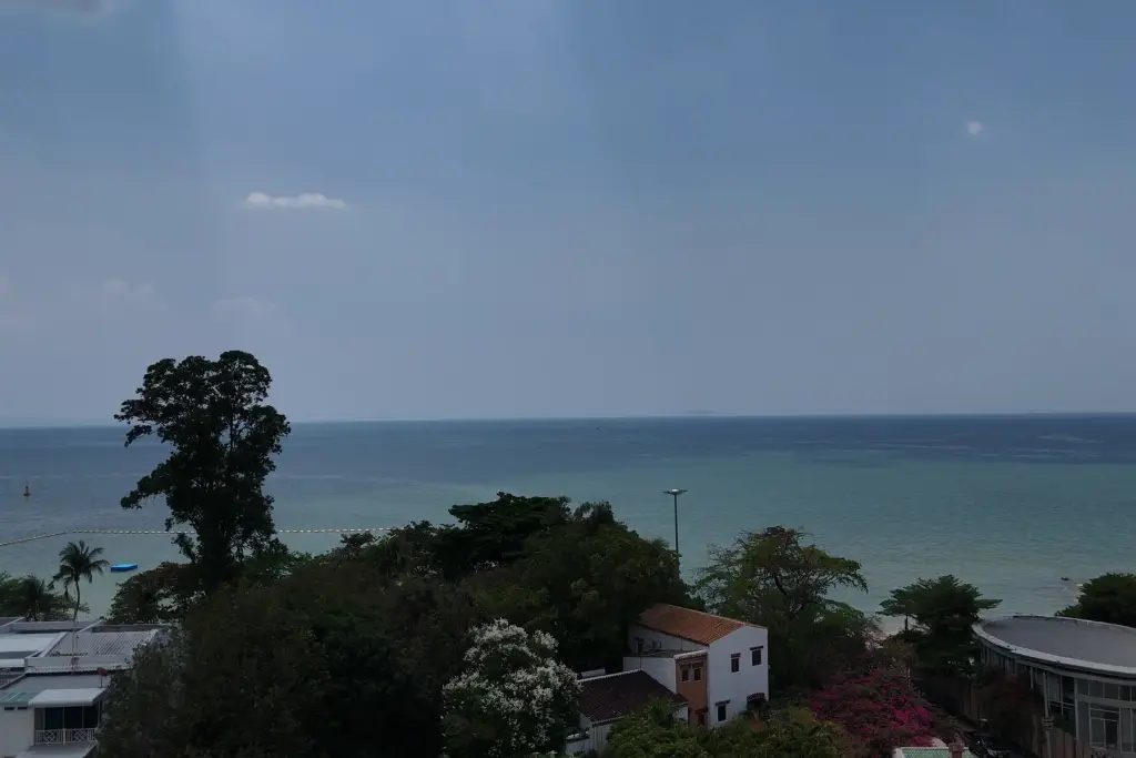 1 Bedroom Condo for Sale at Sea Sky By Sand balcony sea view overlooking Pattaya coastline and rooftops