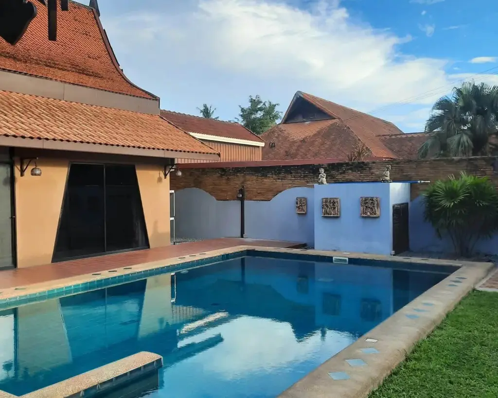 2 Bedroom House for Rent in Mabprachan landscaped garden with swimming pool, topiary trees, and Thai-style gazebo
