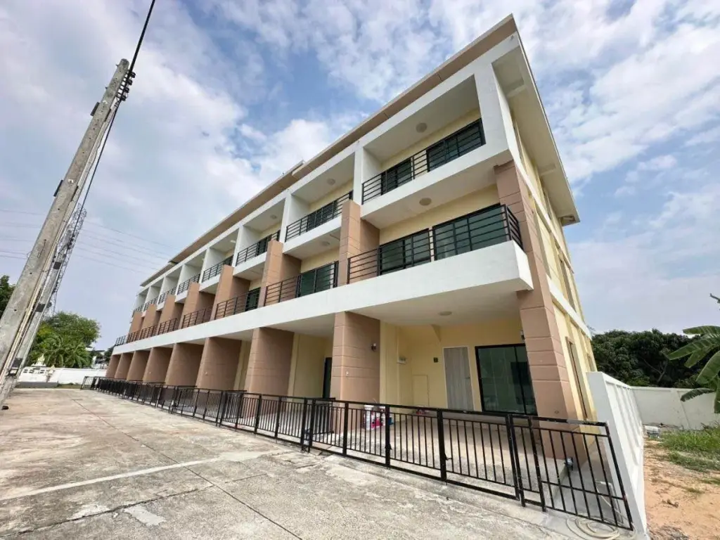 4 Bedroom Townhouse for Sale in Takhian Tia three-story exterior with balconies and black railings under blue sky