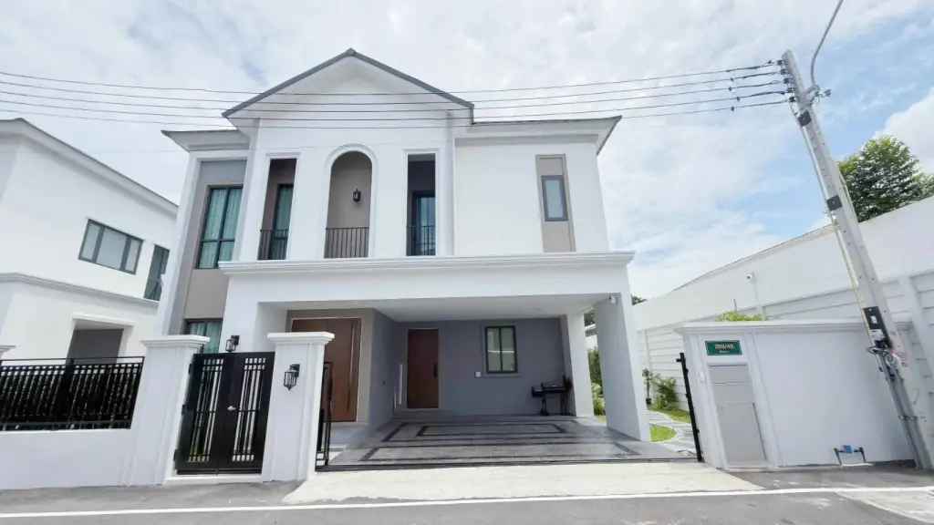 3 Bedroom House for Rent at The Palm Grandio's white two-story facade with black gate and carport