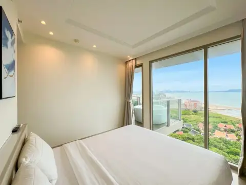 2 Bedroom Condo for Sale at Riviera Monaco bedroom with king bed and framed wall art