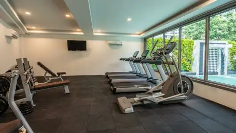 Arcadia Center Suite fitness center with treadmills, weight bench, and pool-view windows
