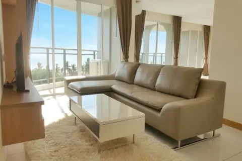 3 Bedroom Condo for Sale at Whale Marina bright living room with L-shaped leather sofa and floor-to-ceiling sea view windows