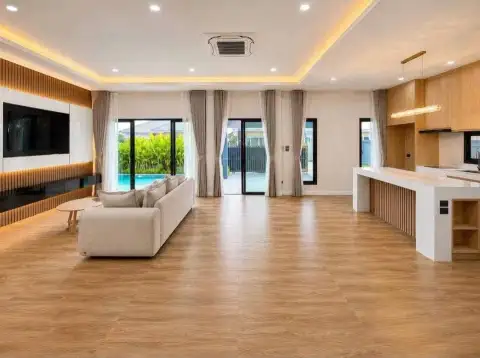 3 Bedroom House for Sale in Pattaya, open-plan living room with wood flooring and kitchen island
