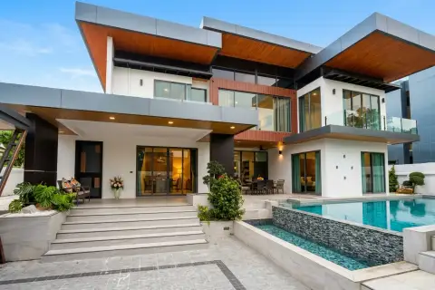 4 Bedroom House for Sale & Rent at M Mountain Village bedroom with blue bedding and black glass wardrobe