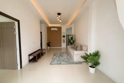 3 Bedroom House for Sale at The Flow Pong - Mabprachan modern facade with covered carport, paved driveway and decorative fence