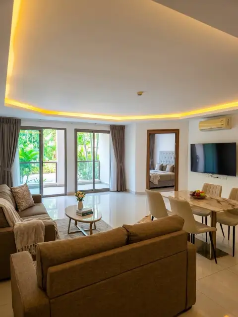 2 Bedroom Condo for Sale at Laguna Beach Resort 3 (The Maldives) living room with balcony access, TV wall, and bedroom entrance
