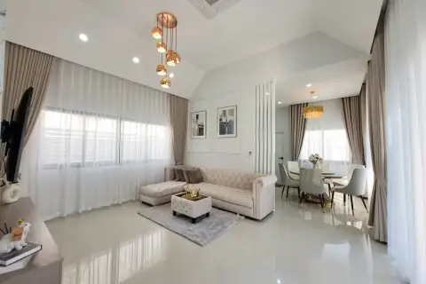 3 Bedroom House for Rent at Pattaya Green Ville bright living room with beige sofa and dining area