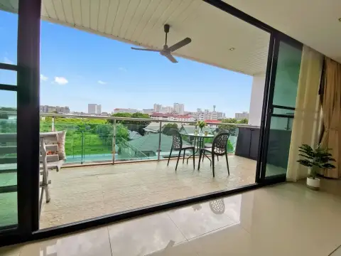 1 Bedroom Condo for Sale at The Park Jomtien private balcony with dining table and panoramic city skyline