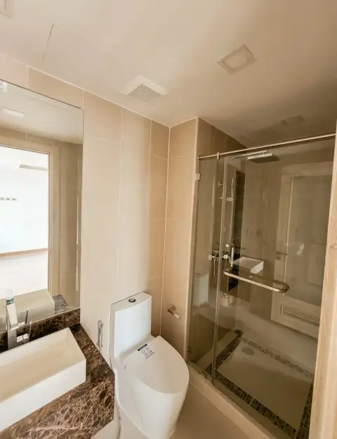 1 Bedroom Condo for Sale at The Peak Towers bathroom with glass shower, marble sink and toilet