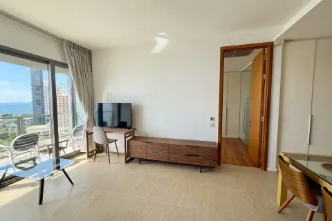 1 Bedroom Condo for Rent at Northpoint bright living room with floor-to-ceiling sliding doors and sea view balcony