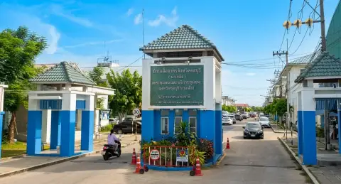 Eua Arthorn Naklua security guard entrance gate with signage at property driveway