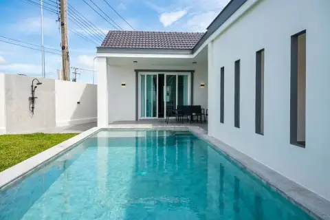 Boonraksa​ Haven​ private pool with outdoor shower, tiled terrace, black patio furniture, and sliding glass doors