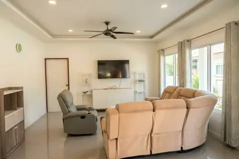 3 Bedroom House for Sale at Siam Executive Estate living room with reclining sofas, TV and ceiling fan