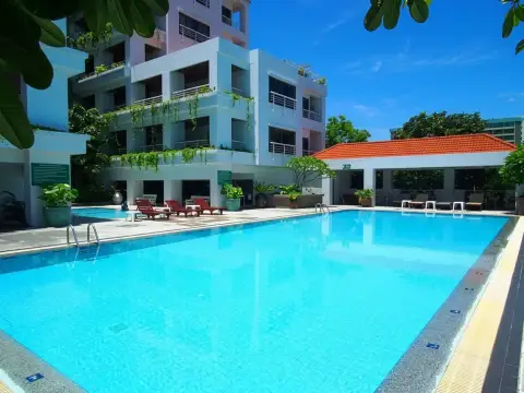Pattaya Hill Resort rectangular pool area with low-rise condo building and lush landscaping