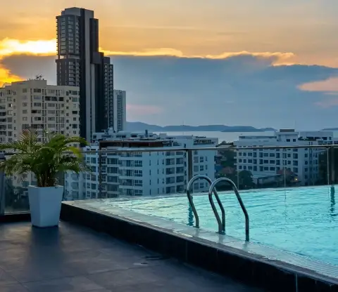 The Winner Pratumnak rooftop infinity pool with sunset city and sea view