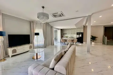 4 Bedroom House for Sale at Srisuk Villa living room with flat-screen TV and open kitchen view