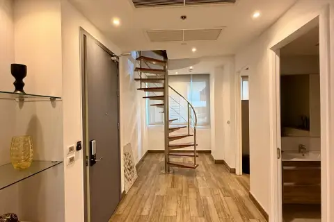 4 Bedroom Condo for Sale at Cetus Beachfront entry hallway with spiral staircase and wood-look tile flooring